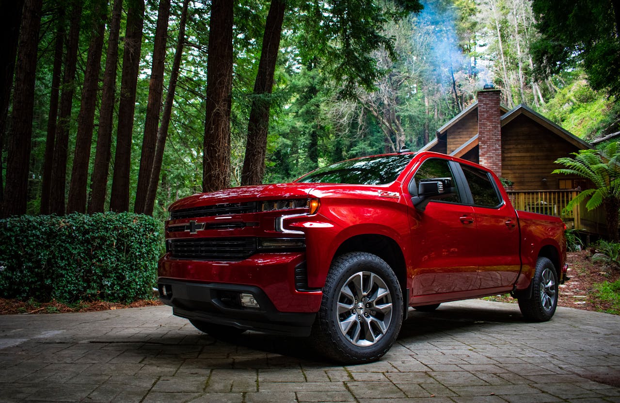 Red Chevrolet Silverado 1500 in the Driveway of a Forest Cottage