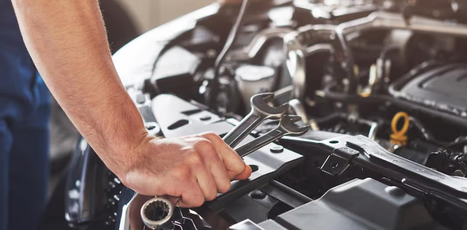 Technician inspecting Chevrolet Equinox engine during service